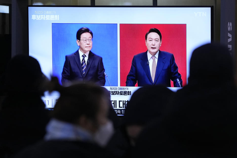 FILE - A TV screen shows presidential candidate Lee Jae-myung of the ruling Democratic Party, left, and Yoon Suk Yeol of the main opposition People Power Party during a presidential debate, at the Seoul Railway Station in Seoul, South Korea on Feb. 21, 2022. An unusually bitter election season in South Korea culminates on Wednesday, March 9 when tens of millions of voters pick their next president. The winner, who will be sworn into office in May and serve one five-year term, will face crucial challenges as the leader of a fast-aging nation that's grappling with economic inequalities, soaring debt and a growing North Korean nuclear threat. (AP Photo/Ahn Young-joon, File)