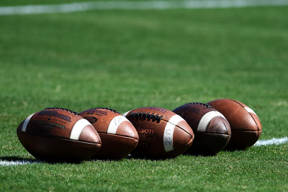 Wilson footballs lined up in a row.