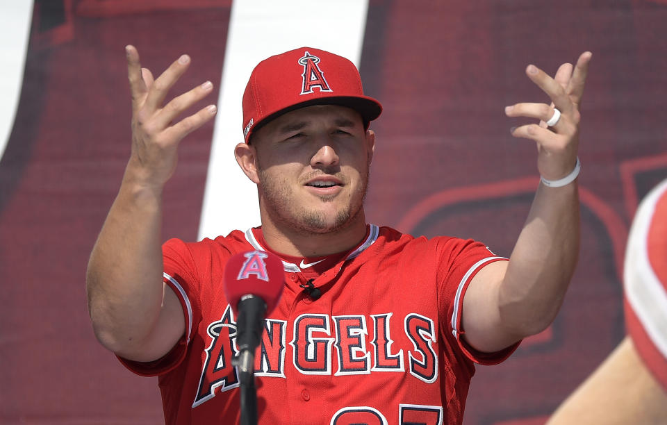 Los Angeles Angels center fielder Mike Trout gestures during a news conference to talk about Trout's 12-year, $426.5 million contract, prior to the team's exhibition baseball game against the Los Angeles Dodgers on Sunday, March 24, 2019, in Anaheim, Calif. (AP Photo/Mark J. Terrill)