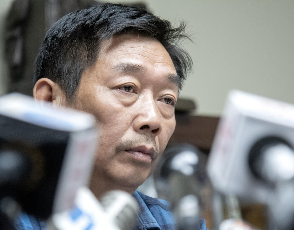 Yingying Zhang's father Ronggao Zhang, listens to a question during a press conference at lawyer Steve Beckett's law office on Wednesday, August 7 2019 Urbana, Ill. The father of the slain scholar who begged his daughter's killer to reveal what he did with her remains so that they could be returned to China for burial says his family now understands that recovering them may be impossible. (Robin Scholz/The News-Gazette via AP )