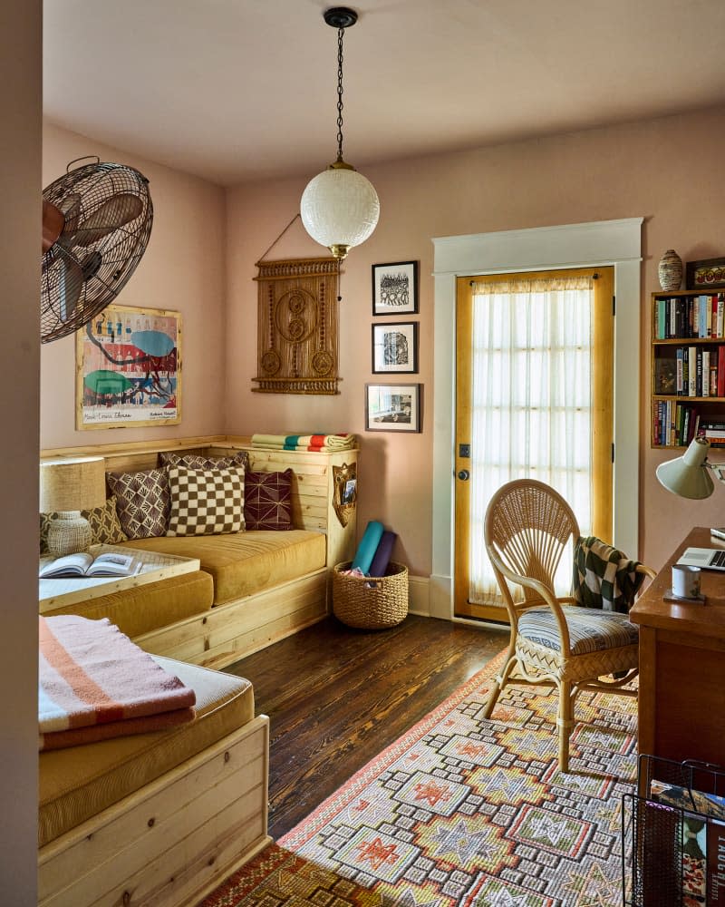 Pink painted walls in office space with built in seating.