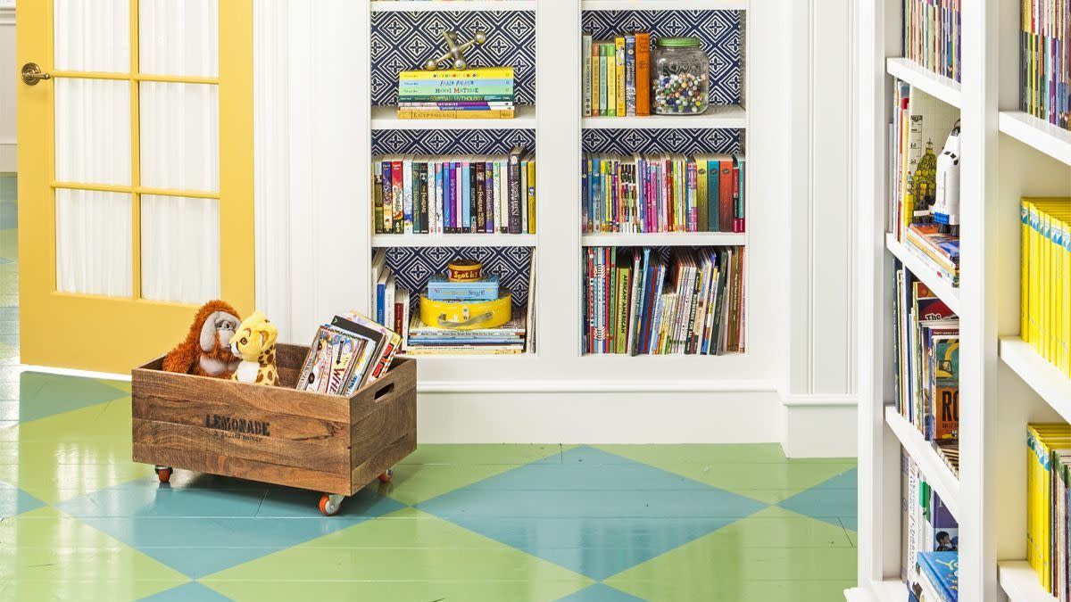 wheeled crate stuffed animal storage idea holding toy giraffe and ape in room with bookshelves