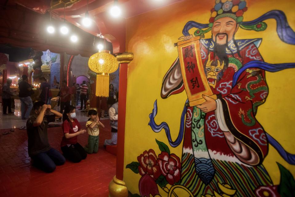 People pray during the Lunar New Year celebration at a temple in Medan, North Sumatra, Indonesia, early Saturday, Feb. 10, 2024. Chinese around the globe are celebrating the Lunar New Year that marks the year of the dragon on the Chinese calendar. (AP Photo/Binsar Bakkara)