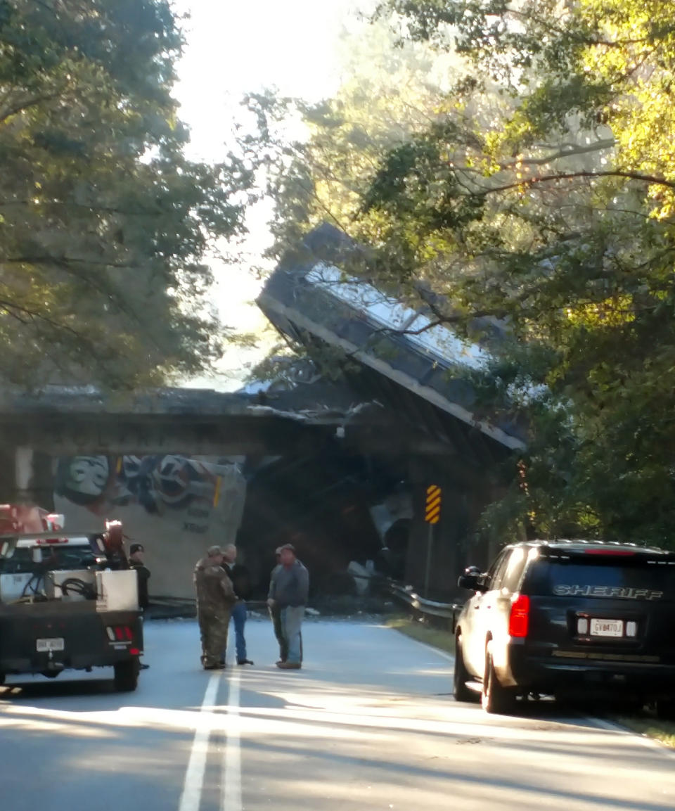 This photo provided by Stephanie Chapman shows emergency personnel working the scene of a train derailment on Saturday, Nov. 17, 2018 in Byromville, Ga. CSX Railroad said the cars derailed around 7 a.m. Saturday in Byromville, roughly 55 miles south of Macon. The exact number of cars involved is unclear. CSX says "several" cars derailed. The town's fire chief, Brett Walls, tells WMAZ-TV that between 15 and 30 cars fell from a bridge onto Georgia Highway 90.