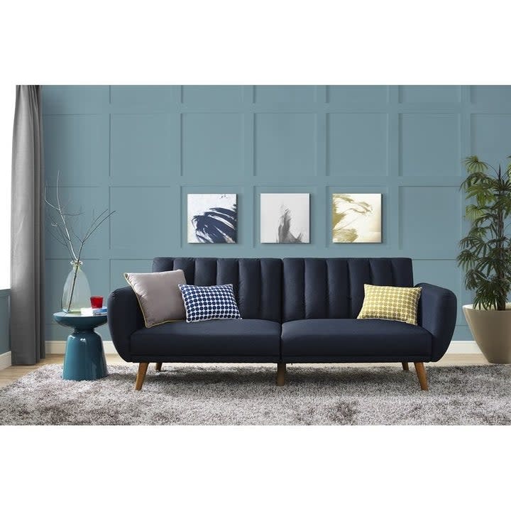 dark blue couch with throw pillows in living room 