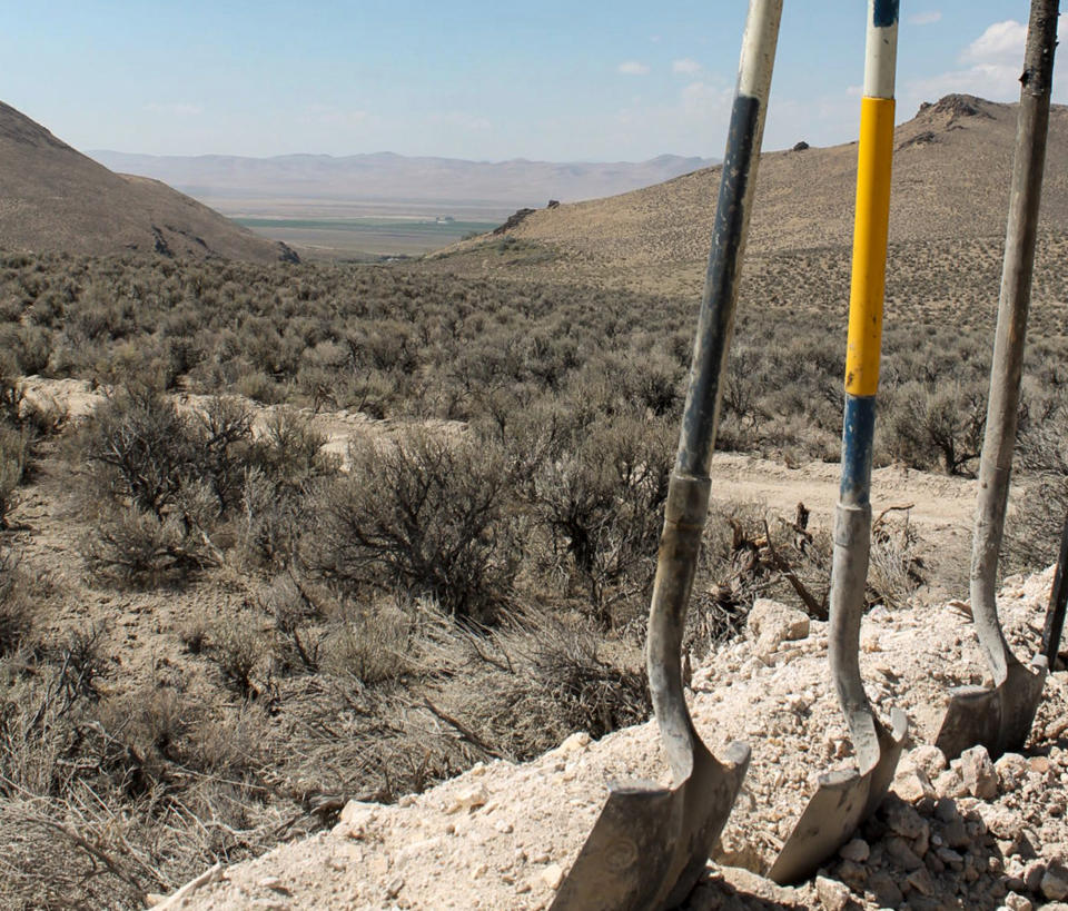 FILE - Exploration drilling continues for Permitting Lithium Nevada Corp.'s Thacker Pass Project on the site between Orovada and Kings Valley, in Humboldt county, Nev., shown beyond a driller's shovels in the distance on Sept. 13, 2018. Conservationists are seeking an emergency court order to block construction of a lithium mine near the Nevada-Oregon line. The new request filed Tuesday, Feb. 21, 2023, in federal court in Reno comes after a judge there directed the U.S. Bureau of Land Management to revisit part of its approval of the plans but allowed construction to go forward in the meantime. (Suzanne Featherston/The Daily Free Press via AP, File)