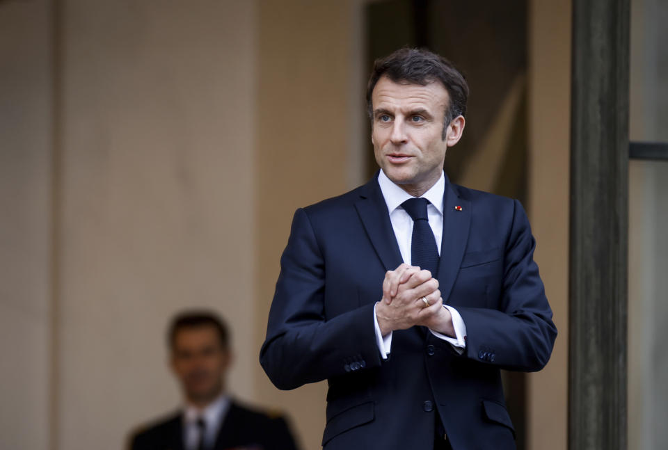 FILE - French President Emmanuel Macron talks to the media as he awaits President of Costa Rica Rodrigo Chaves Robles for a meeting at the Elysee Palace in Paris, on March 24, 2023. Macron has ignited a firestorm of anger with unpopular pension reforms that he rammed through parliament. Young people, some of them first-time demonstrators, are joining protests against him. Violence is also picking up. (AP Photo/Thomas Padilla, File)