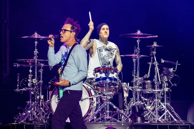 <p>Erika Goldring/WireImage</p> Mark Hoppus and Travis Barker perform with Blink-182 in 2024