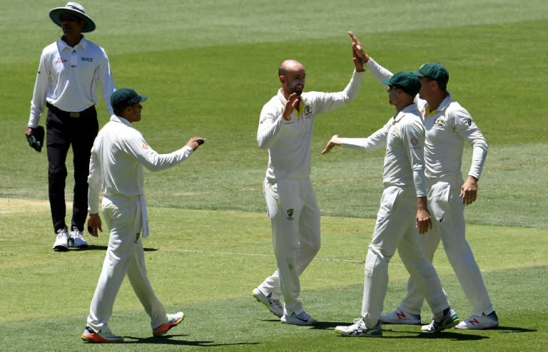 Nathan Lyon (centre) celebrates the dismissal of Rishabh Pant