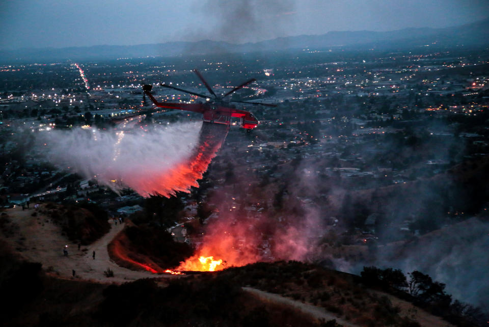 <p>Water is dropped above homes in Sun Valley during the La Tuna Canyon fire over Burbank, Calif., Sept. 2, 2017. (Photo: Kyle Grillot/Reuters) </p>