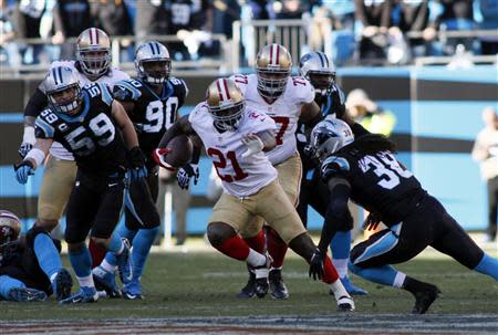 Jan 12, 2014; Charlotte, NC, USA; San Francisco 49ers running back Frank Gore (21) runs against Carolina Panthers strong safety Robert Lester (38) during the second half of the 2013 NFC divisional playoff football game at Bank of America Stadium. Jeremy Brevard-USA TODAY Sports