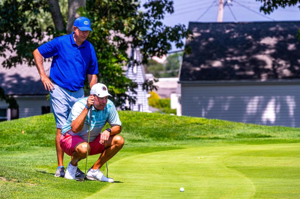 Chris and Mark Giusti study the Green on Hole 9 at the Country Club of New Bedford.