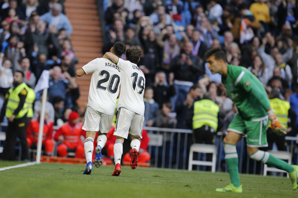 Real Madrid's Marco Asensio, left, celebrates with Alvaro Odriozola after scoring the opening goal during a round of 32, 2nd leg, Spanish Copa del Rey soccer match between Real Madrid and Melilla at the Santiago Bernabeu stadium in Madrid, Spain, Thursday, Dec. 6, 2018. (AP Photo/Paul White)