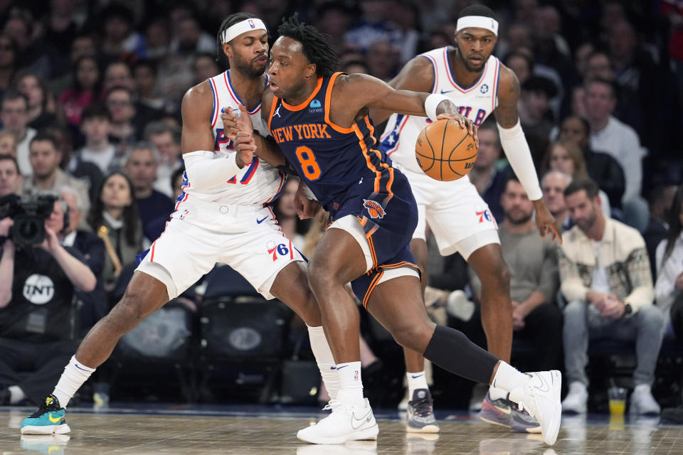 New York Knicks forward OG Anunoby (8) drives against Philadelphia 76ers guard Buddy Hield, left, during the first half of an NBA basketball game Tuesday, March 12, 2024, at Madison Square Garden in New York. (AP Photo/Mary Altaffer)