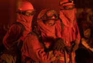 <p>Firefighters look on as flames approach the Casa Loma fire station in the Santa Cruz Mountains near Loma Prieta, California on September 27, 2016. The Loma Prieta Fire has charred more than 1,000 acres and burned multiple structures in the area. (Josh Edelson/AFP/Getty Images)</p>