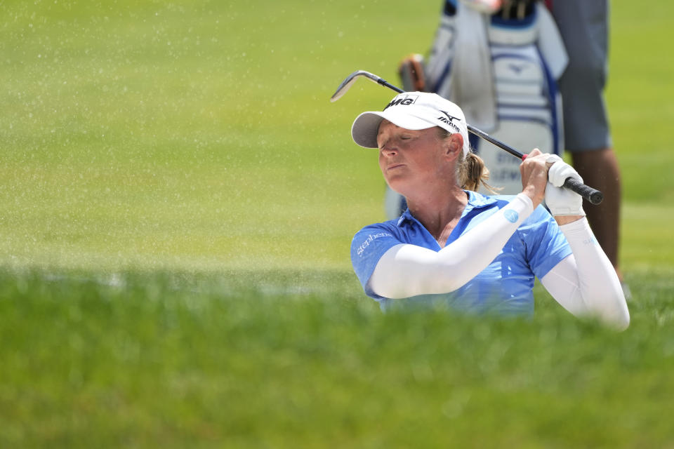 Stacy Lewis closes her eyes after hitting from the sand onto the 17th green during the third round of the Dow Great Lakes Bay Invitational golf tournament at Midland Country Club, Friday, July 21, 2023, in Midland, Mich. (AP Photo/Carlos Osorio)