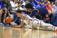 Florida guard Riley Kugel, left, and Auburn guard Aden Holloway (1) knock the ball out of bounds during the second half of an NCAA college basketball game Saturday, Feb. 10, 2024, in Gainesville, Fla. (AP Photo/Alan Youngblood)