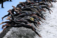 <p>Athletes jump into the river waters during the Lisbon ETU Triathlon European Championships, in Lisbon, Portugal, May 28, 2016. (EPA/JOAO RELVAS) </p>