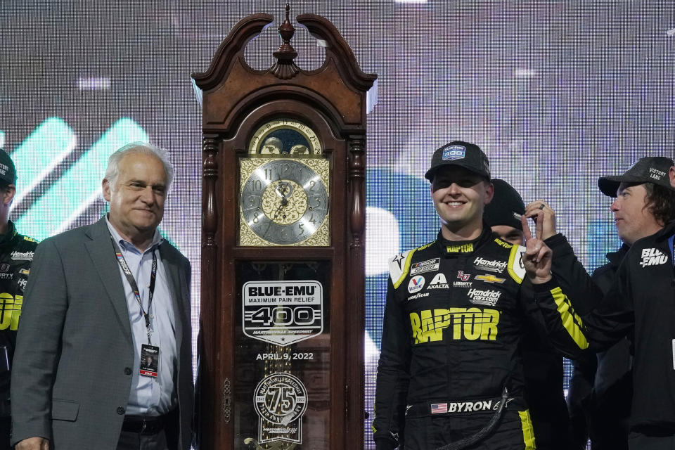William Byron, right, and track president Clay Campbell, left, stand next to the trophy after Byron won the NASCAR Cup Series auto race at Martinsville Speedway on Saturday, April 9, 2022, in Martinsville, Va. (AP Photo/Steve Helber)