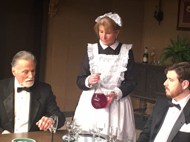 Left to right, Larry Lickteig as Arthur Birling, Cissy George as Edna and Dan Svirsky as Gerald Croft imbibe in an after-dinner drink of port in the Barnstable Comedy Club's rehearsal for "An Inspector Calls."