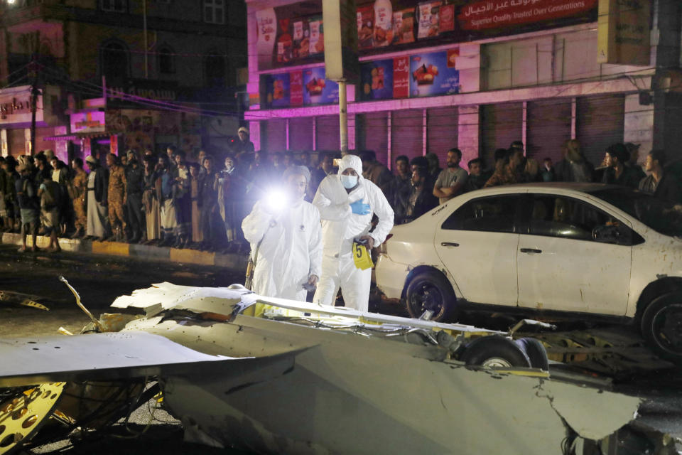 Forensic experts inspect the wreckage of a drone aircraft which Houthi rebels claimed to have shot down, in Sanaa, Yemen, Monday, May 23, 2022. (AP Photo/Hani Mohammed)