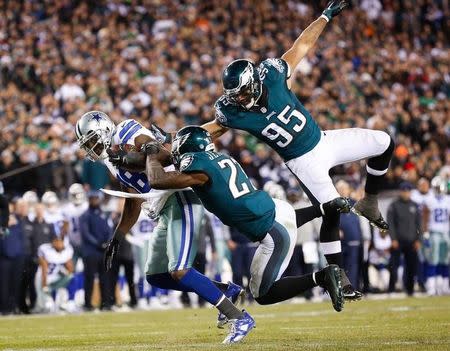 Dallas Cowboys wide receiver Dez Bryant (88) makes a reception past Philadelphia Eagles free safety Malcolm Jenkins (27) and inside linebacker Mychal Kendricks (95) during the second half at Lincoln Financial Field. Dec 14, 2014; Philadelphia, PA, USA; Bill Streicher-USA TODAY Sports