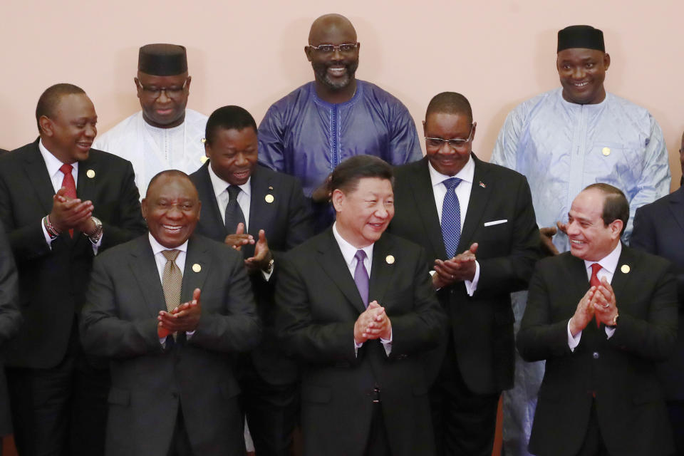 FILE - In this Sept. 3, 2018, file photo, Chinese President Xi Jinping, front center, South African President Cyril Ramaphosa, front row left, Egyptian President Abdel Fattah al-Sisi, front right, Kenya's President Uhuru Kenyatta, second row left, Togo's President Faure Gnassingbe, second row center, Malawi's President Arthur Peter Mutharika, third row right, Sierra Leone President Julius Maada Bio, third row left, Liberian President George Weah, third row center, with other African leaders clap during a group photo session at the Forum on China-Africa Cooperation (FOCAC) 2018 Beijing Summit in Beijing. China's loans to poor countries in Africa and Asia impose unusual secrecy and repayment terms that are hurting their ability to renegotiate debts after the coronavirus pandemic, a group of U.S. and German researchers said in a report Wednesday, March 31, 2021. (How Hwee Young/Pool Photo via AP, File)