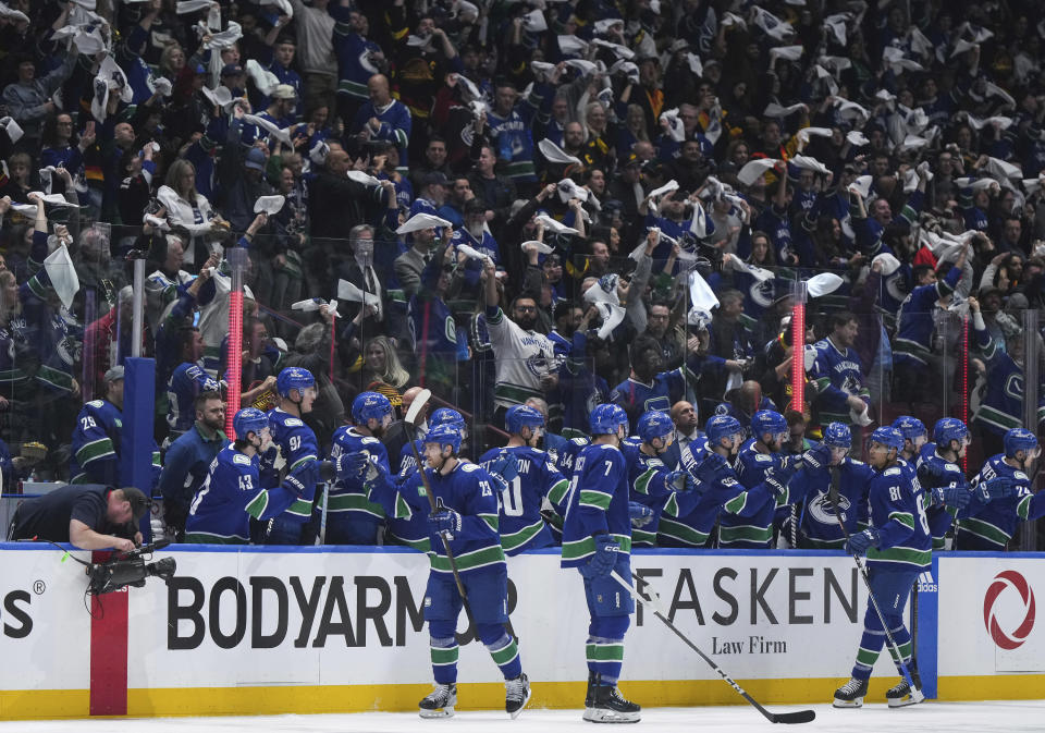 Vancouver Canucks' Elias Lindholm (23) celebrates his goal with the team bench against the Nashville Predators during the second period in Game 1 of an NHL hockey Stanley Cup first-round playoff series in Vancouver, British Columbia, on Sunday, April 21, 2024. (Darryl Dyck/The Canadian Press via AP)