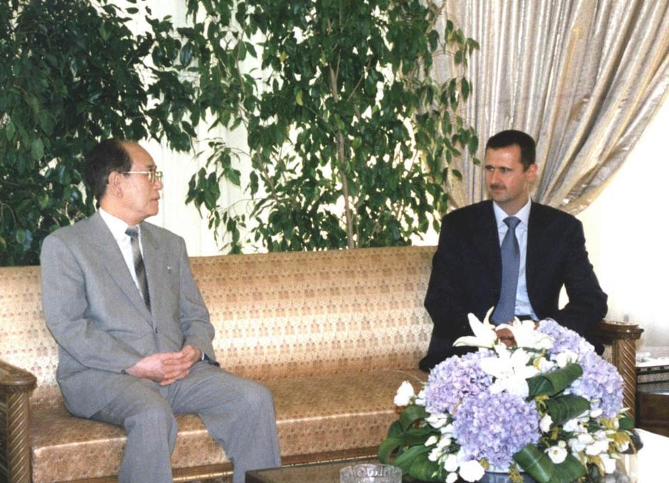 Syrian President Bashar Assad meets with North Korea's second leader, Kim Yong-Nam, in Damascus at the end of the latter's three-day visit to Syria 18 July 2002.