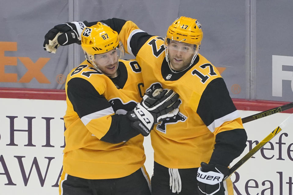 FILE - Pittsburgh Penguins' Sidney Crosby (87) celebrates his first-period goal with Bryan Rust (17) during an NHL hockey game against the New Jersey Devils in Pittsburgh, in this Thursday, April 22, 2021, file photo. In a way, the NHL's COVID-19 protocols may have been a blessing to the Pittsburgh Penguins. The rules forced the Penguins to basically hole up in the hotel while on the road, offering them time to build chemistry, one of the main reasons they were able to win their first division title in seven years. (AP Photo/Gene J. Puskar, File)