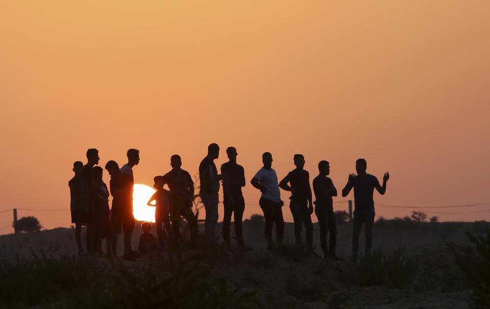 Protesters gather on a hill at the entrance of Erez border crossing between Gaza and Israel, in the northern Gaza Strip, Tuesday, Sept. 4, 2018. The Health Ministry in Gaza says several Palestinians were wounded by Israeli fire as they protested near the territory's main personnel crossing with Israel. (AP Photo/Adel Hana)