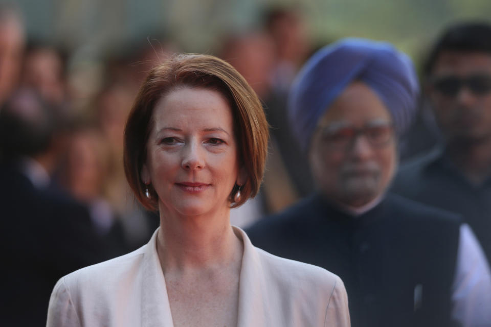 Australian Prime Minister Julia Gillard, arrives with her Indian counterpart Manmohan Singh, at the Indian Presidential palace for ceremonial reception, in New Delhi, India , Wednesday, Oct. 17, 2012. (AP Photo/ Manish Swarup)