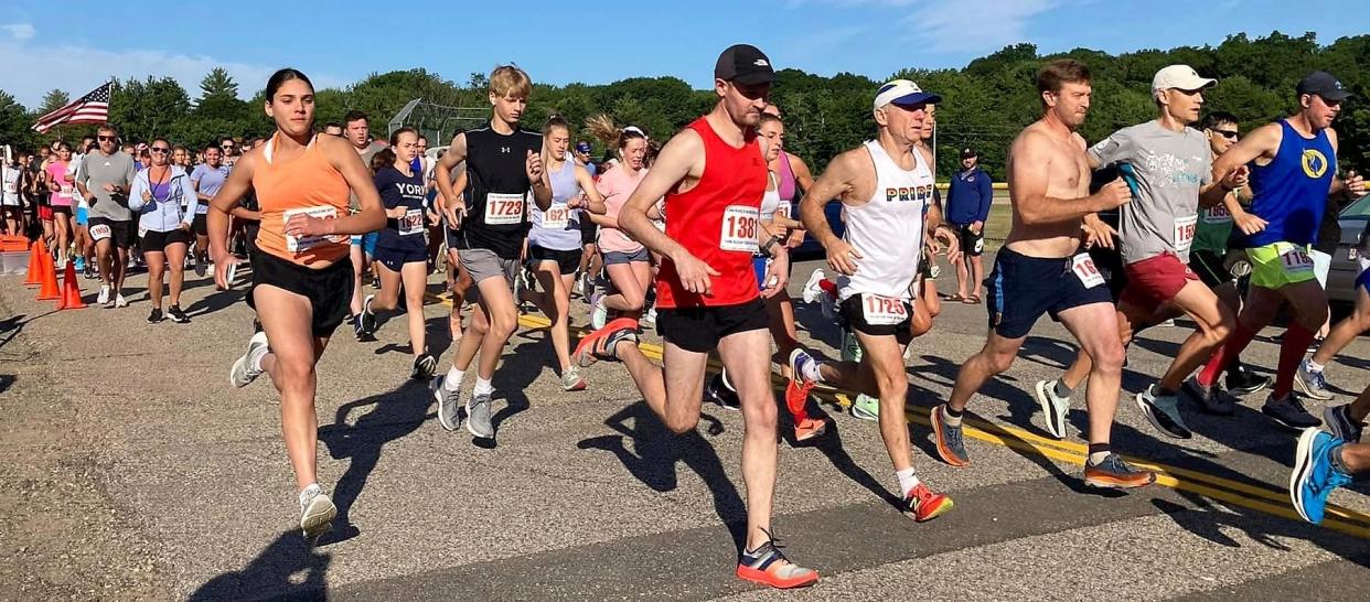 Runners take off near the starting line at Monday's annual York Four on the Fourth road race. There were more than 800 registered runners for the race which was held for the first time since 2019. Jefferson Tucker, of Cape Neddick, Maine was the first to cross the finish line in a time of 21 minutes, 29 seconds.