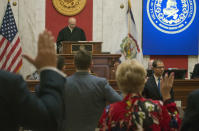 Judge Paul Farrell, left at rostrum, presides over the Senate as senators are sworn in during a pre-trial impeachment conference for four impeached Supreme Court justices in the West Virginia State Senate chambers at the Capitol in Charleston, W,Va., Tuesday, Sept. 11, 2018. Trial dates have not been set. (AP Photo/Steve Helber)