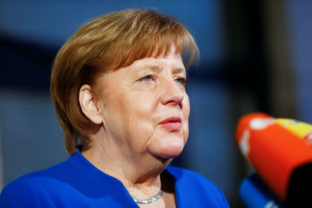 Acting German Chancellor Angela Merkel arrives for exploratory talks about forming a new coalition government at the SPD headquarters in Berlin, Germany, January 11, 2018. REUTERS/Hannibal Hanschke