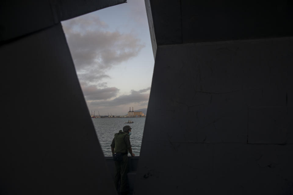 An Israeli soldier wears a face mask to help curb the spread of the coronavirus stands in his position on board the Israeli Navy Ship Lahav during a rare tour of Israel's offshore Leviathan gas field in the Mediterranean Sea, Tuesday, Sept. 29, 2020. After a coronavirus-related delay, Israel's navy is preparing for the long-awaited arrival of its next generation of missile boats - giving it a powerful new tool to defend its strategic natural gas industry from the threat of the Lebanese militant group Hezbollah. (AP Photo/Ariel Schalit)