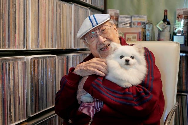 Cordeiro holds his dog at home in Hong Kong