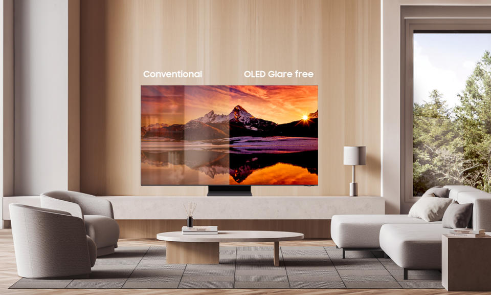 Lifestyle product shot of a Samsung OLED TV in a fancy modern living room. On the left shows simulated glare on a conventional TV. On the right, the lack of glare on the Samsung.