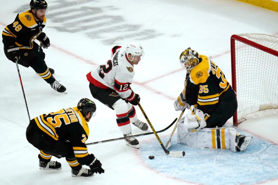 Boston Bruins goaltender Linus Ullmark (35) makes a stick save on a shot by Ottawa Senators right wing Alex DeBrincat (12) during the second period of an NHL hockey game, Tuesday, March 21, 2023, in Boston. (AP Photo/Charles Krupa)