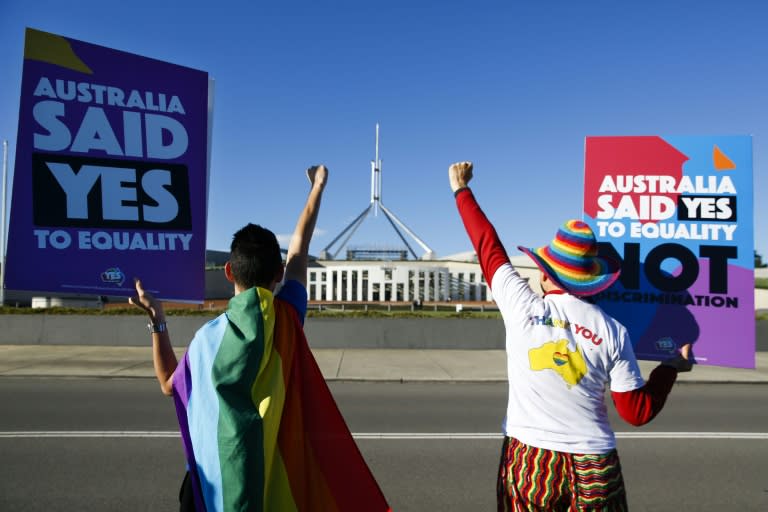 Same-sex marriage campaigners cheer in front of Australia's parliament ahead of the vote