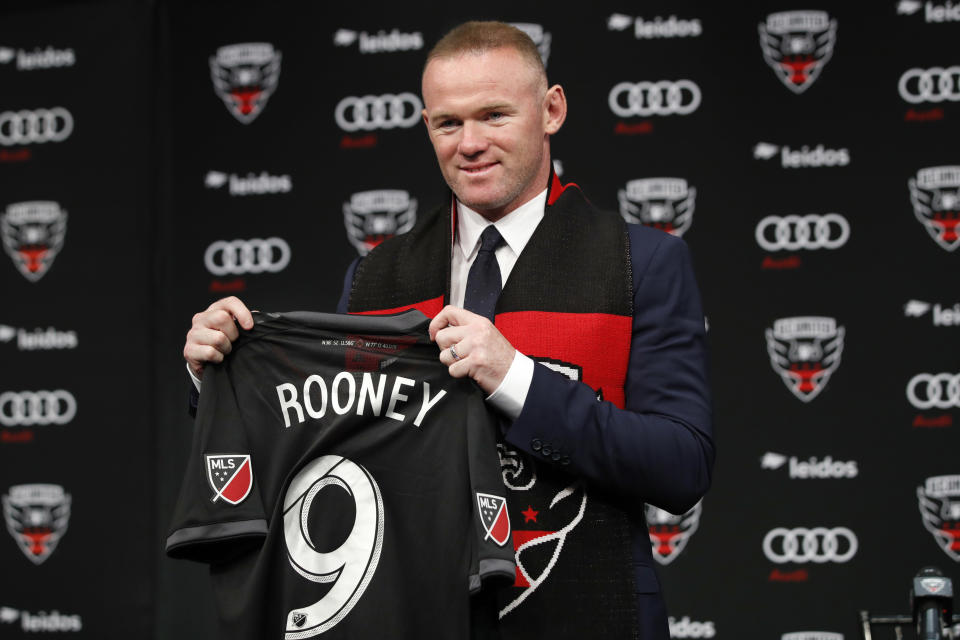 Wayne Rooney, the all-time leading scorer for England’s national team and Manchester United in the Premier League, poses with his new jersey. (AP Photo/Jacquelyn Martin)