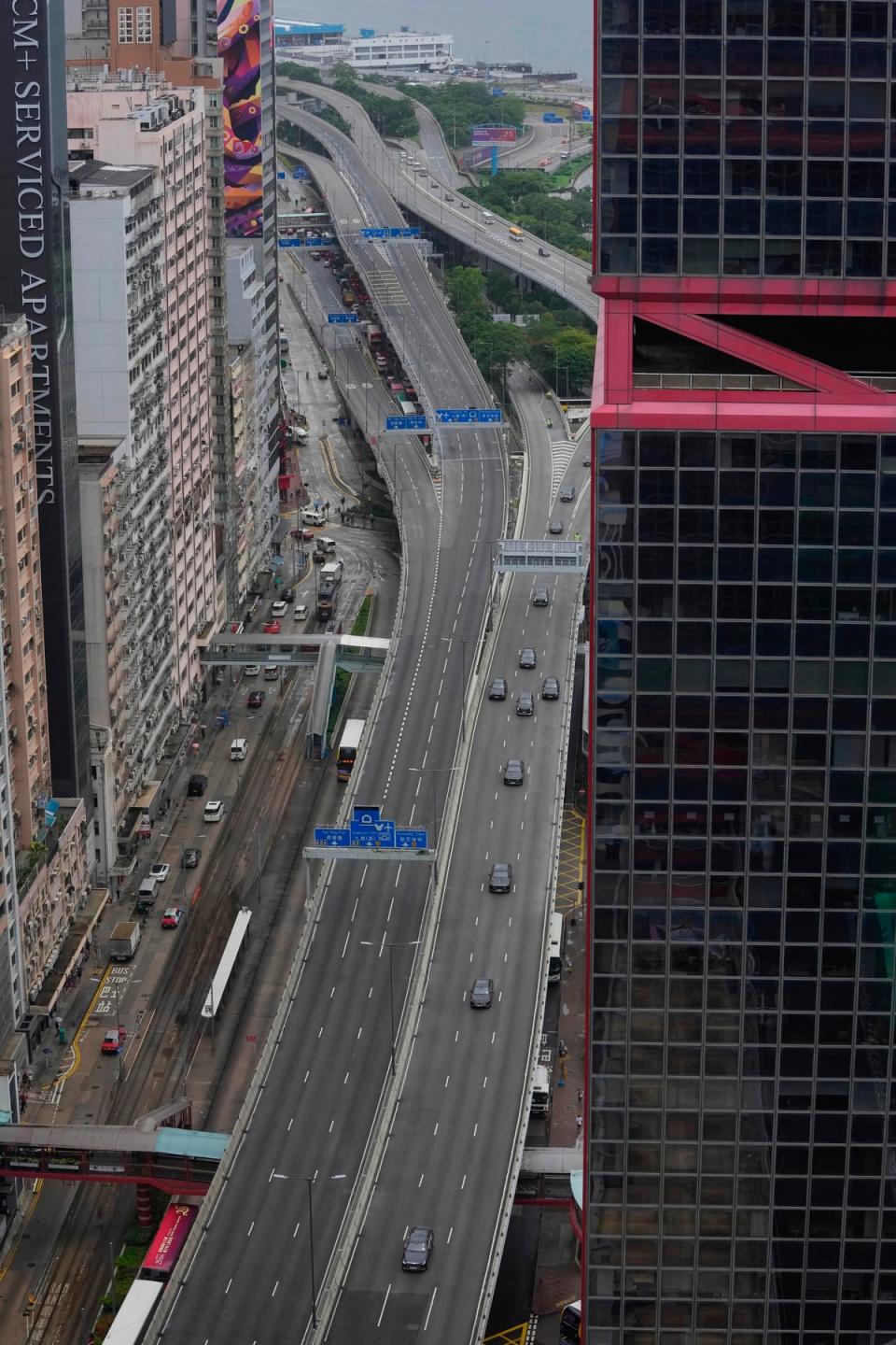 A convoy of China’s president Xi Jinping drives past as he arrives to mark the 25th anniversary of the handover (AP)