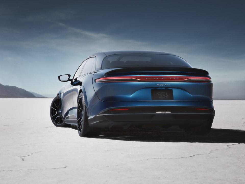 The Lucid Air Sapphire on a snowy surface against a blue sky.