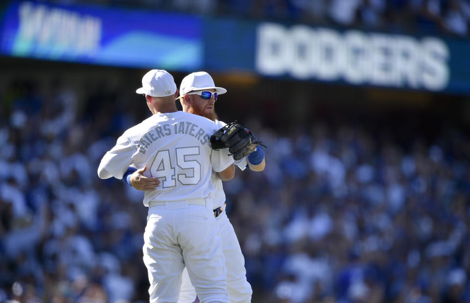 Los Angeles Dodgers' Justin Turner, right, celebrates with Matt Beaty after a baseball game against the New York Yankees in Los Angeles, Saturday, Aug. 24, 2019. (AP Photo/Kelvin Kuo)