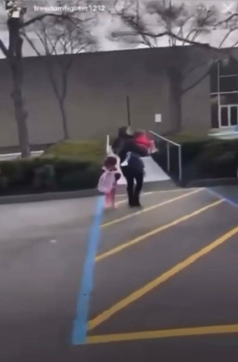 In a screen capture taken from a video on the Instagram account freedomfighter1212, a woman with two children outside Temple Beth El's preschool in Bloomfield Township are yelled at by Hassan Yehia Chokr on Dec. 2, 2022. Still from video Chokr recorded as he stalked and harassed people, making anti-Jewish and anti-Black remarks.