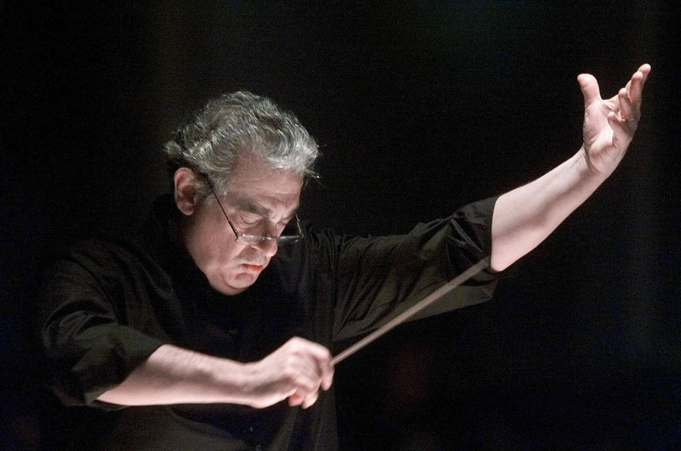 FILE - In this Jan. 27, 2001, file photo, Placido Domingo directs the Washington Opera Orchestra and Chorus during a rehearsal of Verdi's Requiem at Washington's Constitution Hall. Domingo is scheduled to appear onstage at the Salzburg Festival Aug. 25, 2019, to perform for the first time since multiple women have accused the opera legend of sexual harassment in allegations brought to light by The Associated Press. (AP Photo/Richard Drew, File)