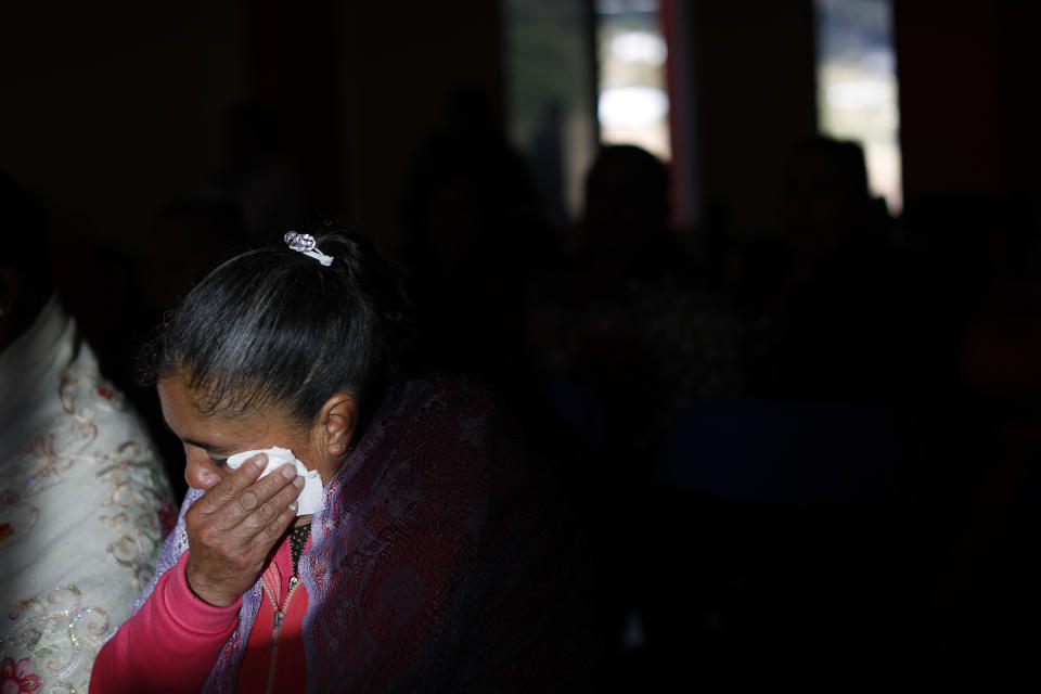 A mourner wipes away tears during a wake for environmental activist Homero Gomez Gonzalez, in Ocampo, Michoacan state, Mexico, Thursday, Jan. 30, 2020. Relatives of the anti-logging activist who fought to protect the winter habitat of monarch butterflies don't know whether he was murdered or died accidentally, but they say they do know one thing for sure: something bad is happening to rights and environmental activists in Mexico, and people are afraid.(AP Photo/Rebecca Blackwell)