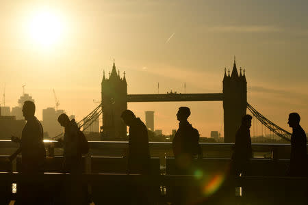 Workers are seen crossing London Bridge with Tower Bridge seen behind during the morning rush hour in London, Britain, September 25, 2018. REUTERS/Toby Melville