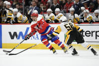 Washington Capitals left wing Alex Ovechkin (8), of Russia, skates with the puck next to Pittsburgh Penguins defenseman Kris Letang (58) during the second period of an NHL hockey game, Sunday, Feb. 2, 2020, in Washington. (AP Photo/Nick Wass)