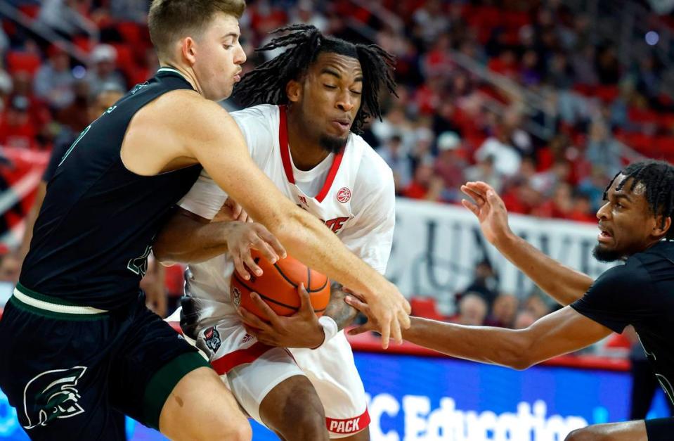 N.C. State’s Jayden Taylor (1) drives by Mount Olive’s Colin Radcliffe (25) during the first half of N.C. State’s exhibition game against Mount Olive at PNC Arena in Raleigh, N.C., Wednesday, Nov. 1, 2023.